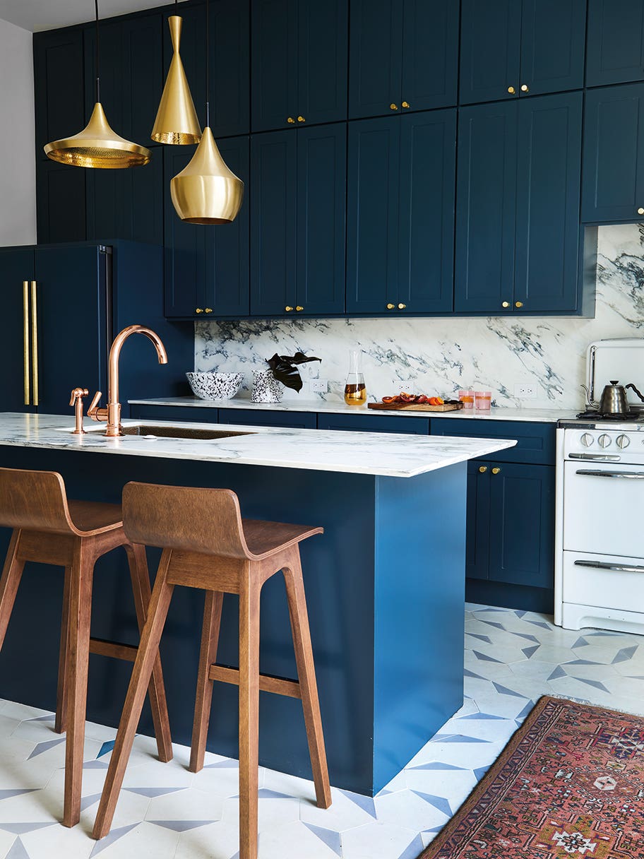 navy kitchen cabinet with brass pendant lights