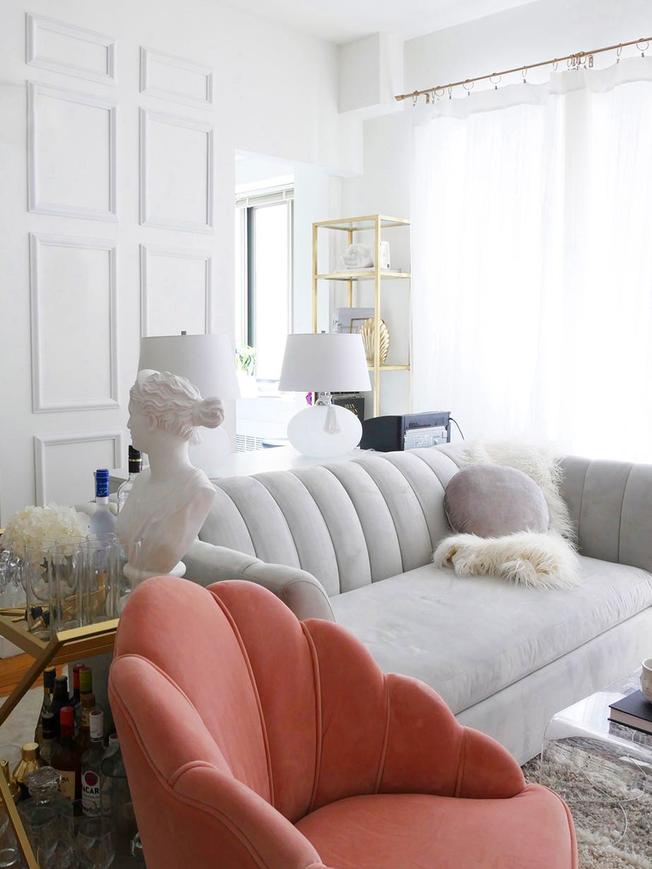 chic living room with pink chair and gray sofa