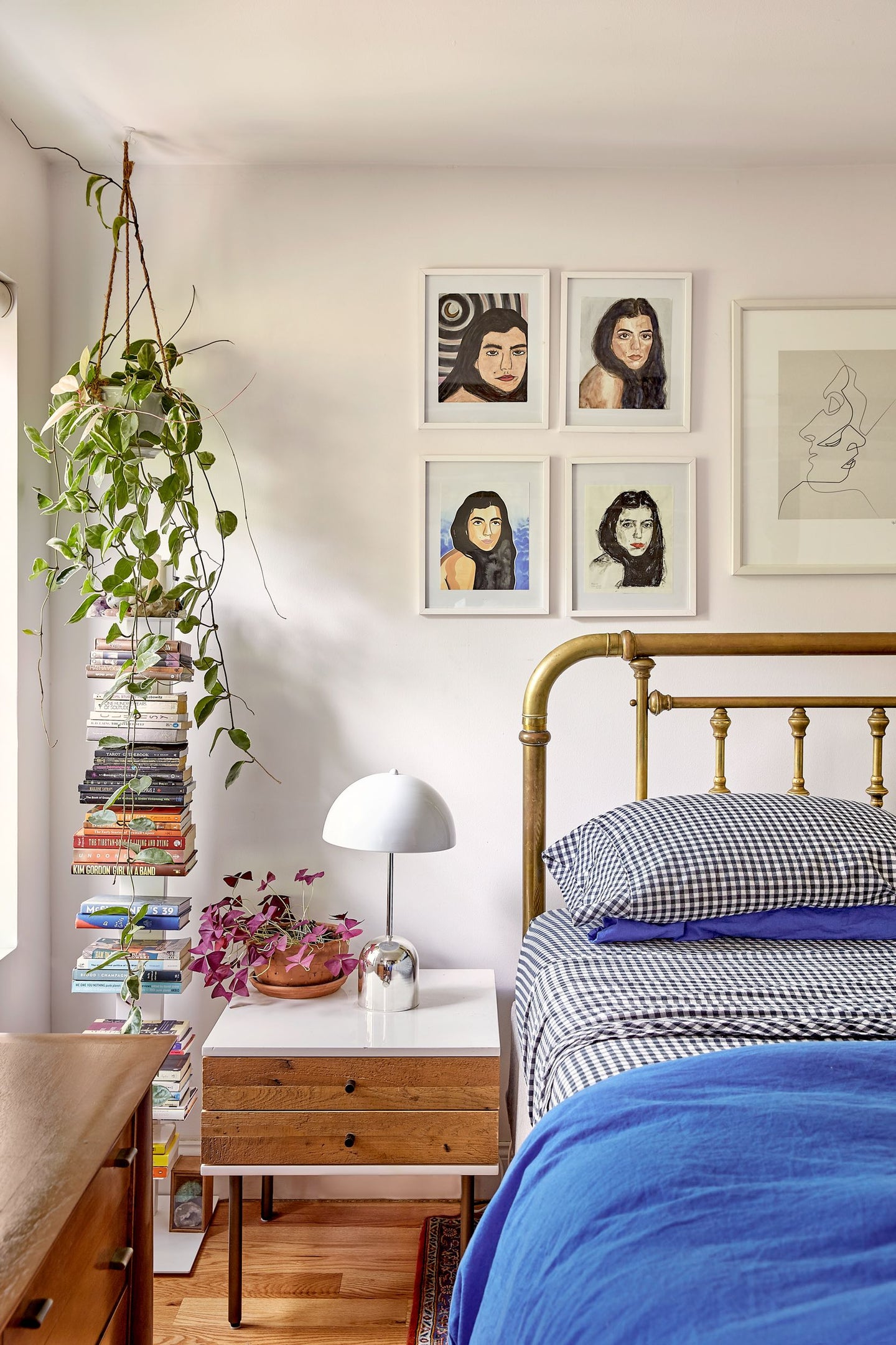 Bedroom with a plant and stack of books