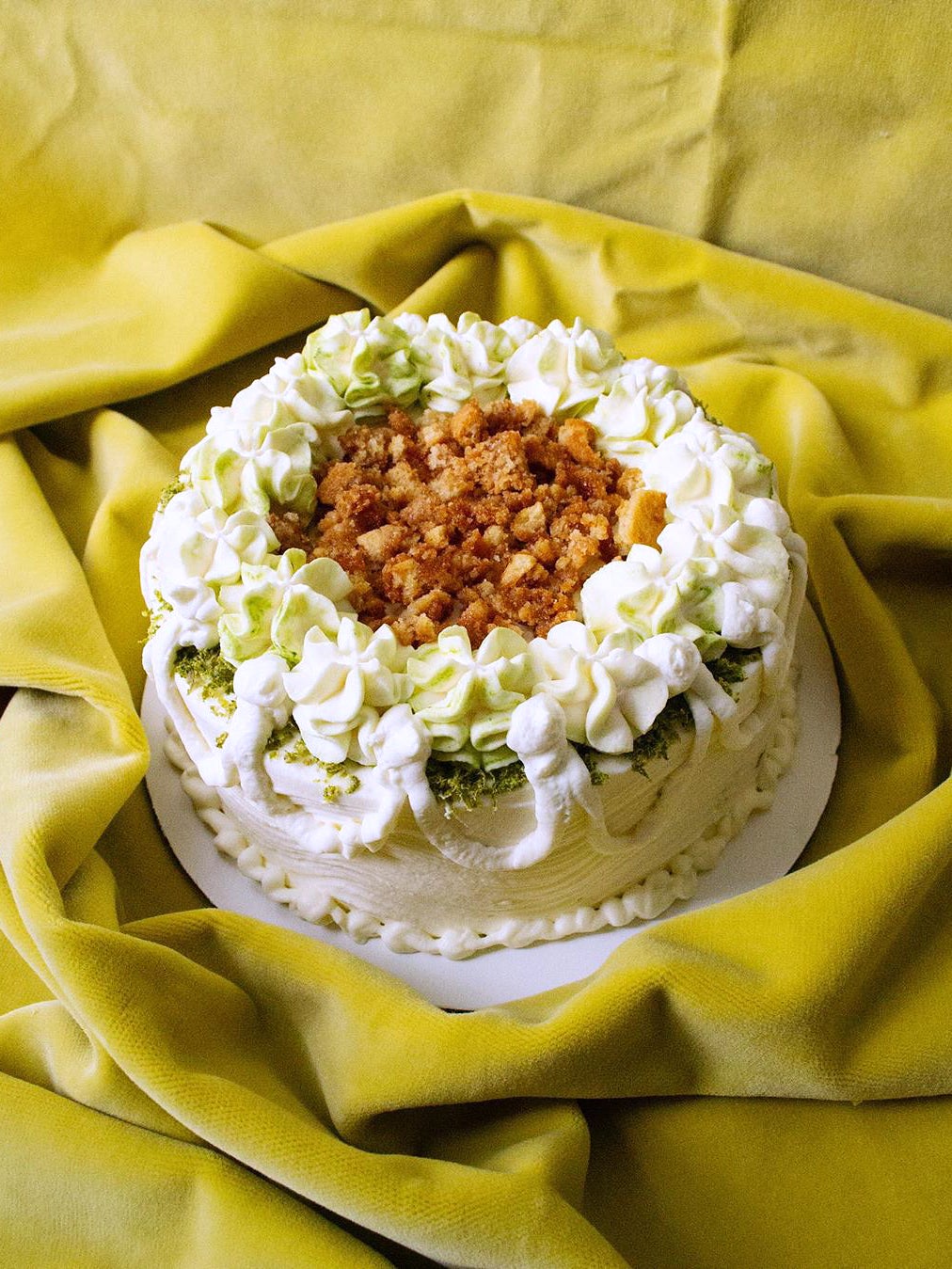 White cake against yellow background