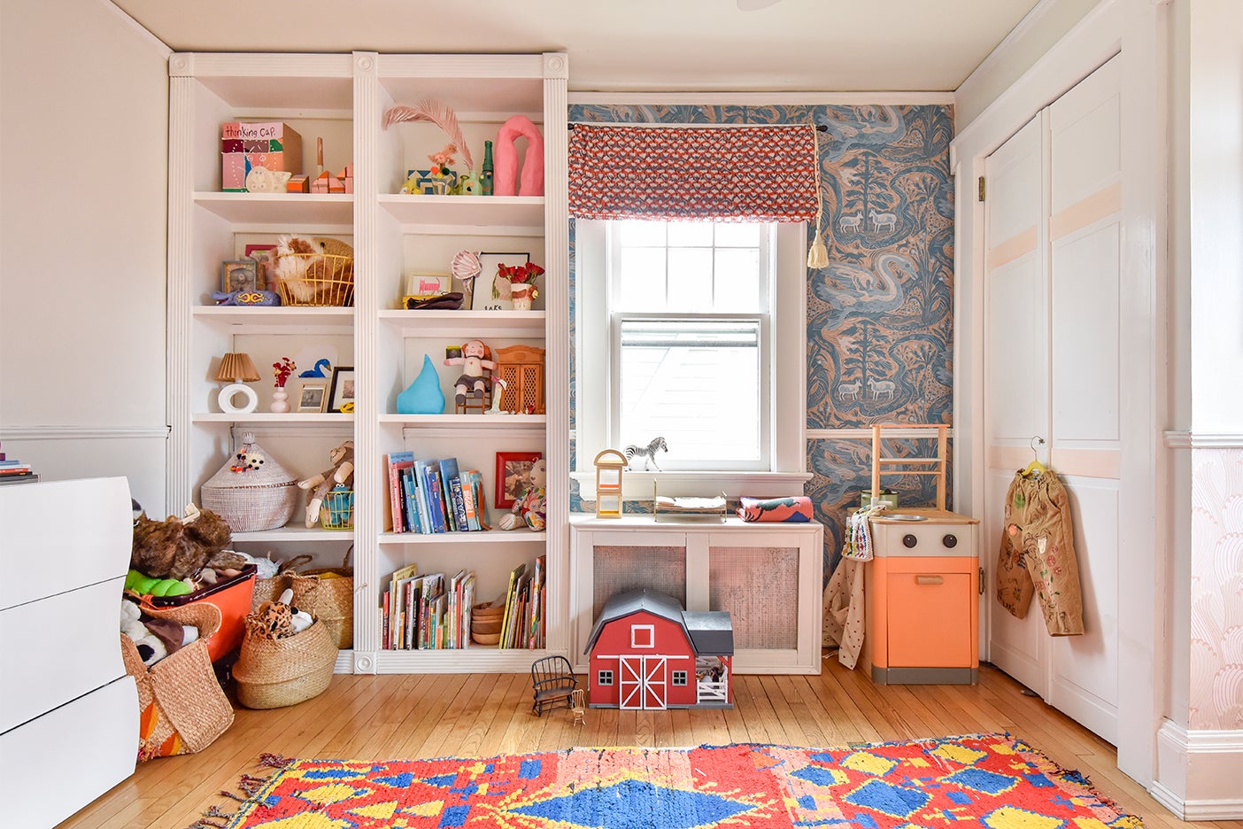 Kids room with bookcases and floral wallpaper