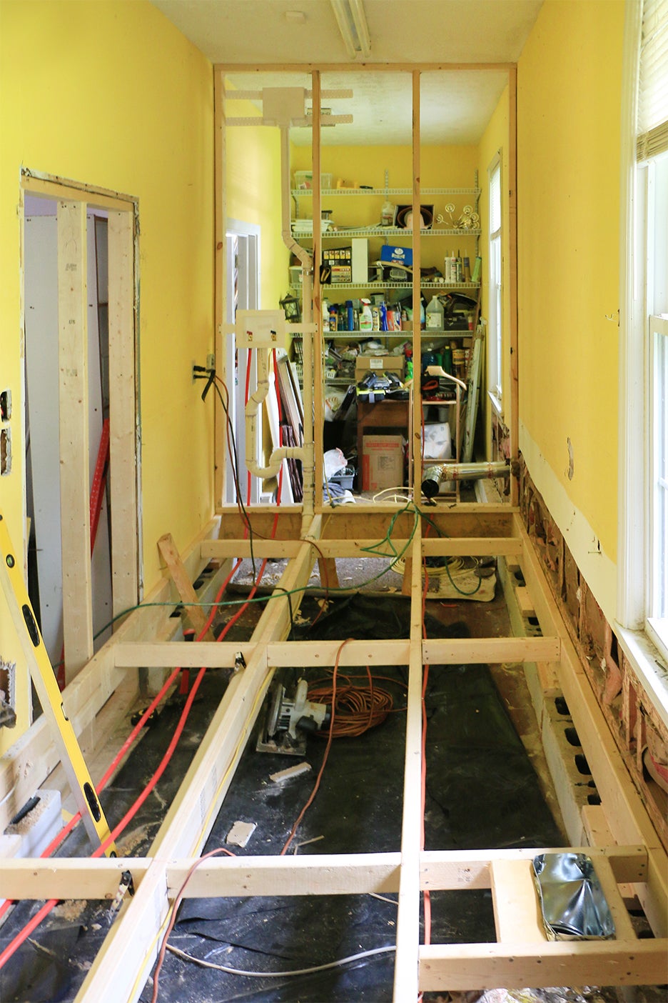 yellow room with exposed floor joists