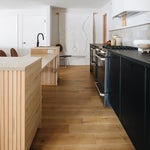 black and white kitchen with wooden island