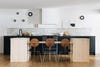 white kitchen with wooden island and black cabinets