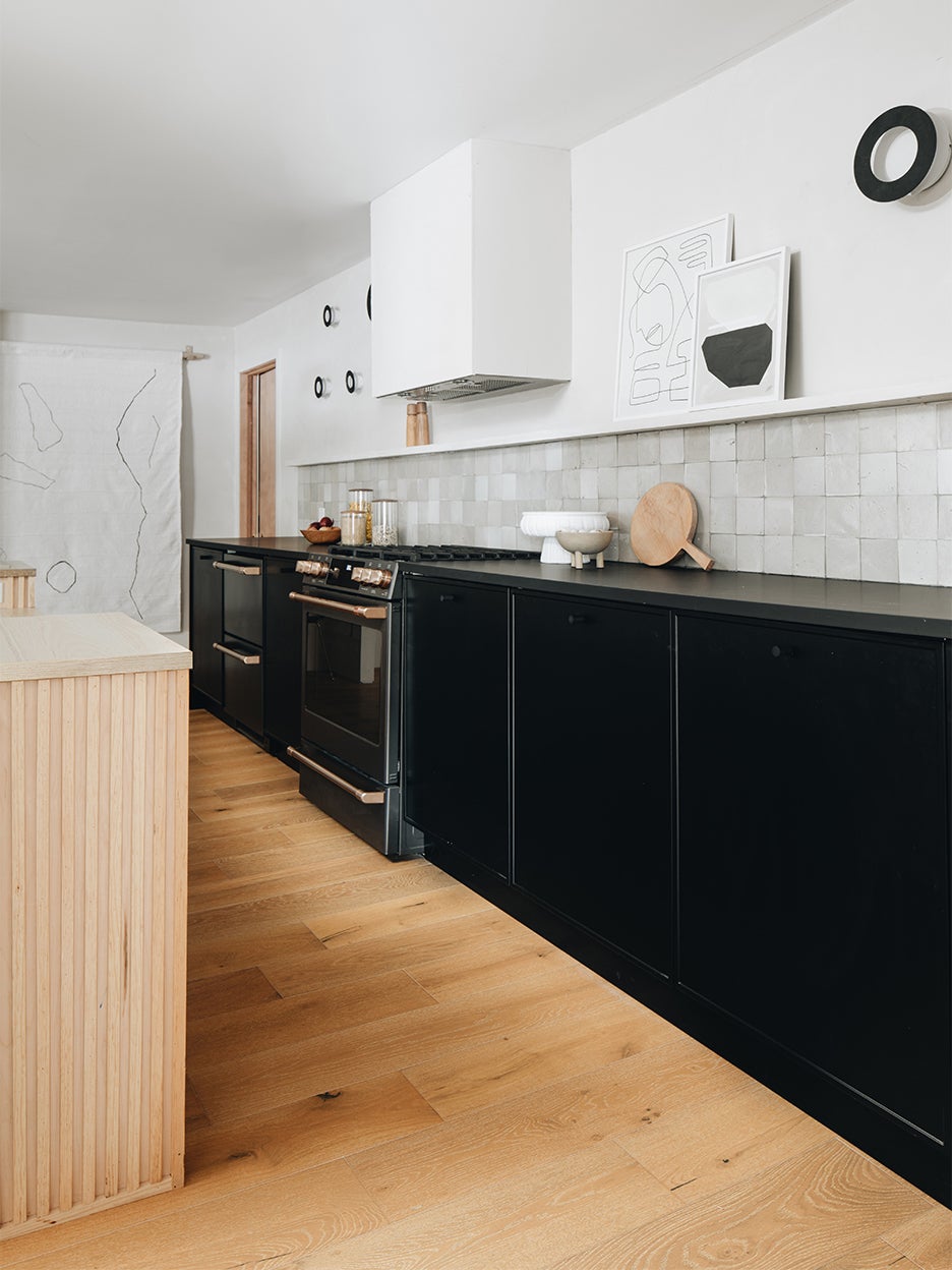 black and white kitchen with wood island