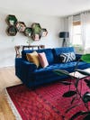 living room with blue velvet sofa