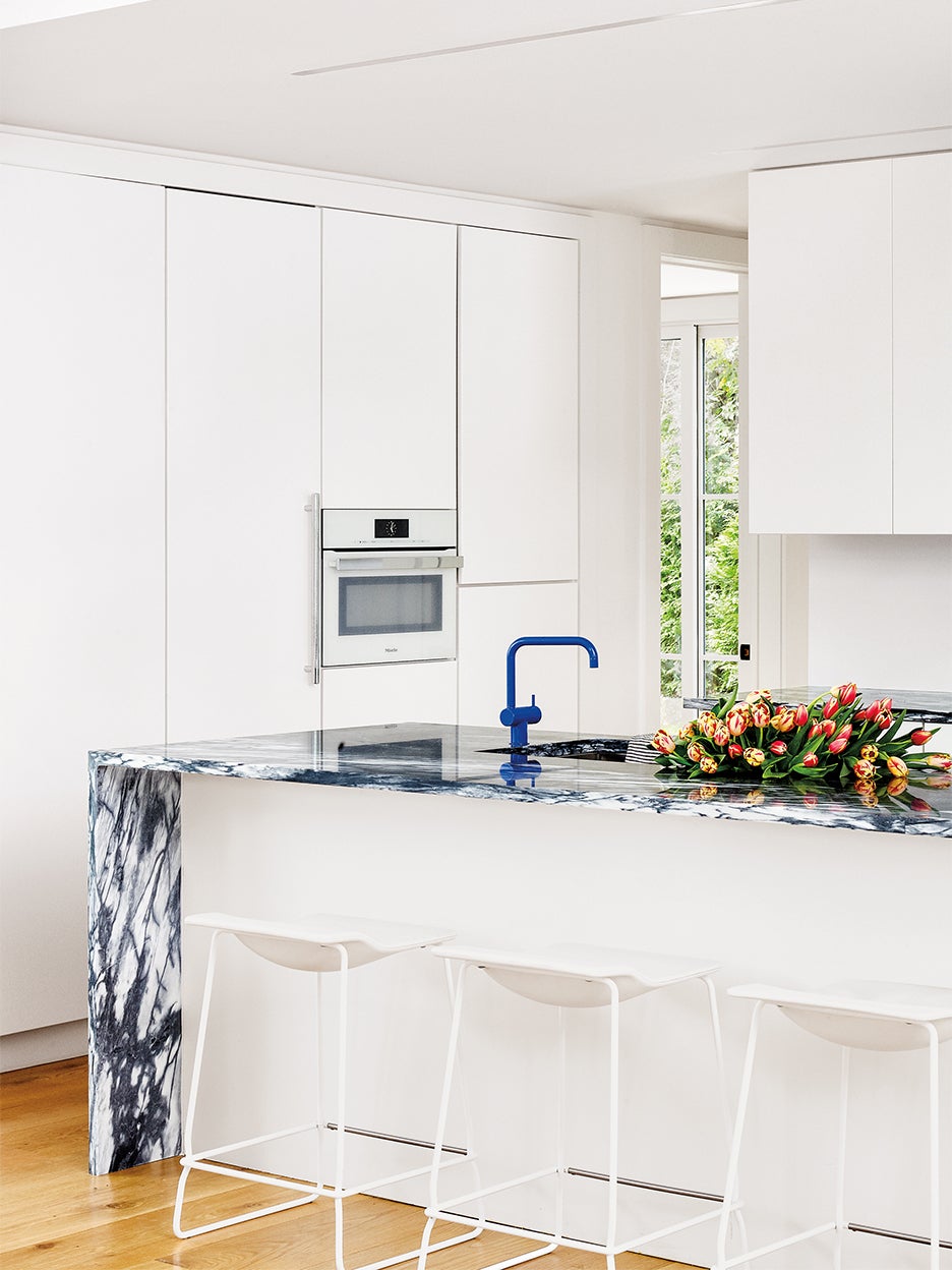 white kitchen with blue marble countertop island