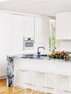 white kitchen with blue marble countertop island