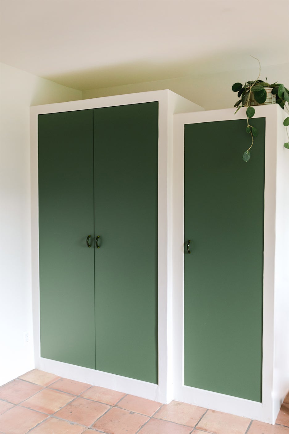 white built ins with green doors