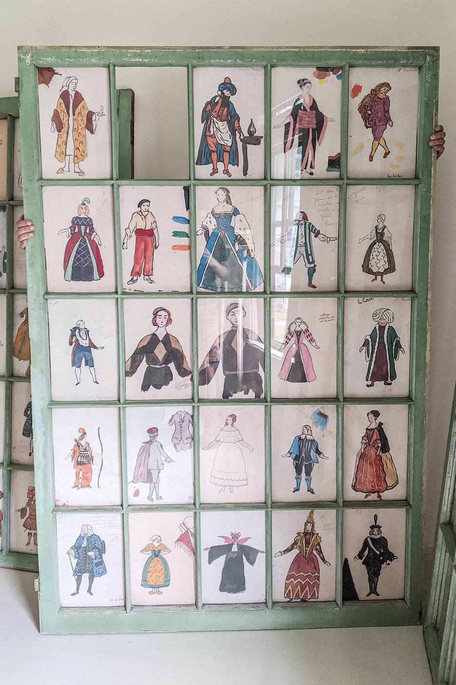 drawings of characters behind a window pane