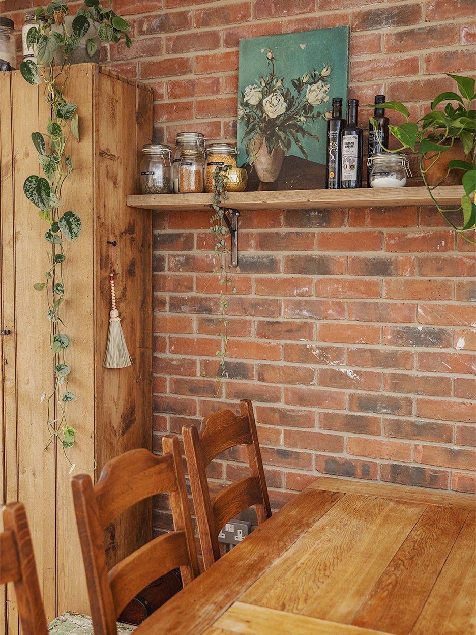 dining table in front of brick wall