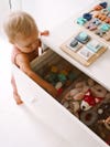 baby getting toys out of a drawer