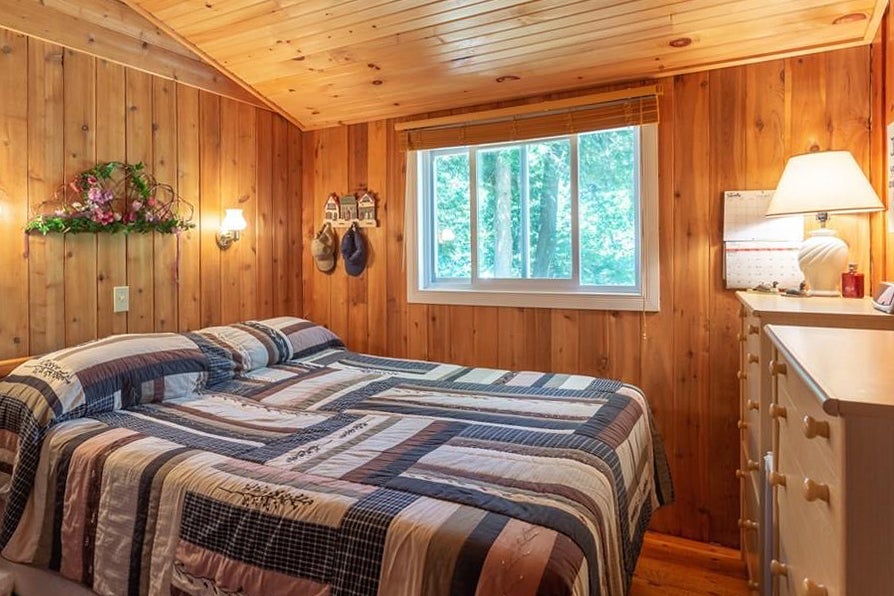 Wood-paneled bedroom