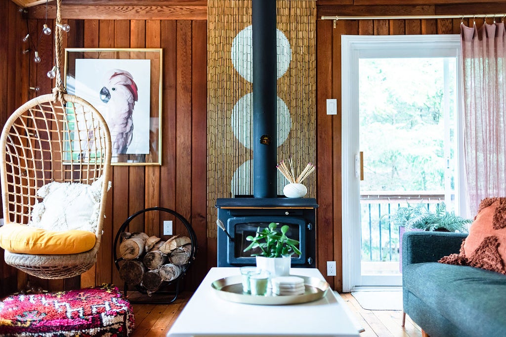 Wood-paneled living room with wood-burning stove
