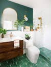green bathroom with wood sink vanity