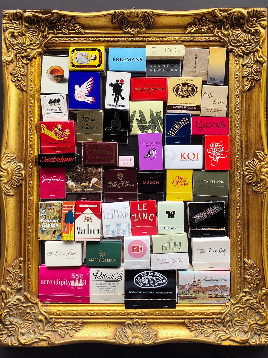 colorful matchboxes laid out on a gold frame