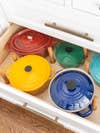 Colorful Dutch ovens in drawer