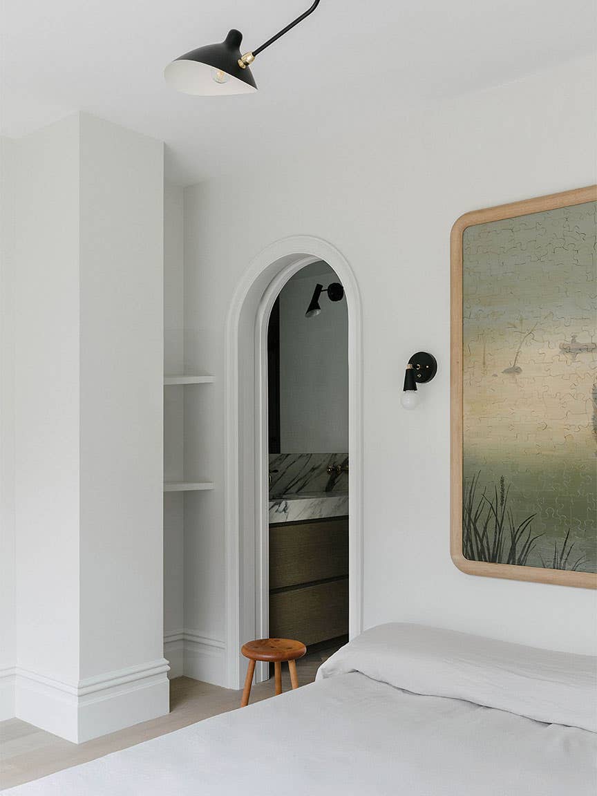 white bedroom with modern art