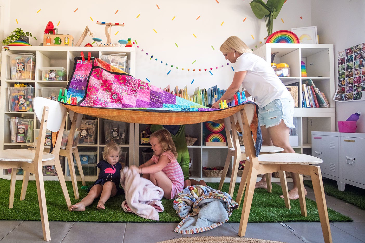 family playing in colorful playroom