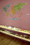 pink wall map decal and shelves with trays
