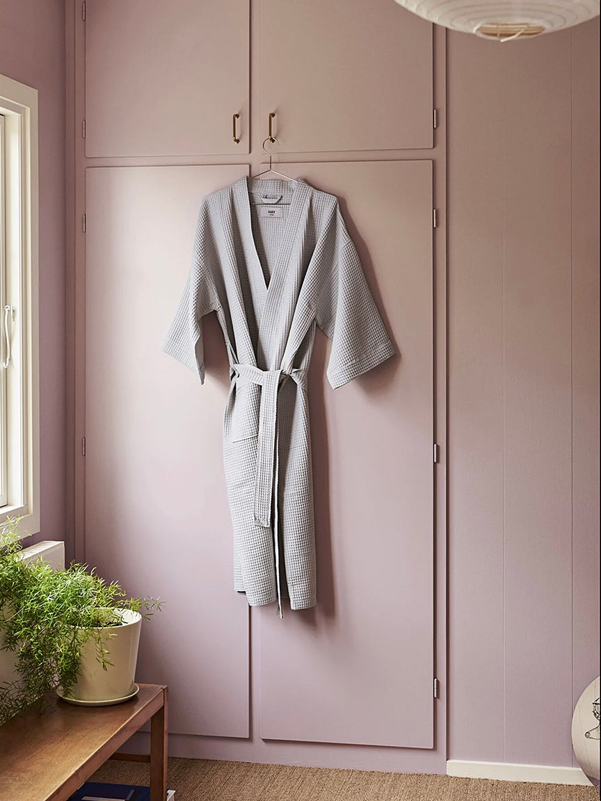 bathrobe hanging in front of a pink closet