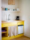 yellow kitchen with sink skirt