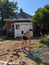 woman digging in dirt in backyard