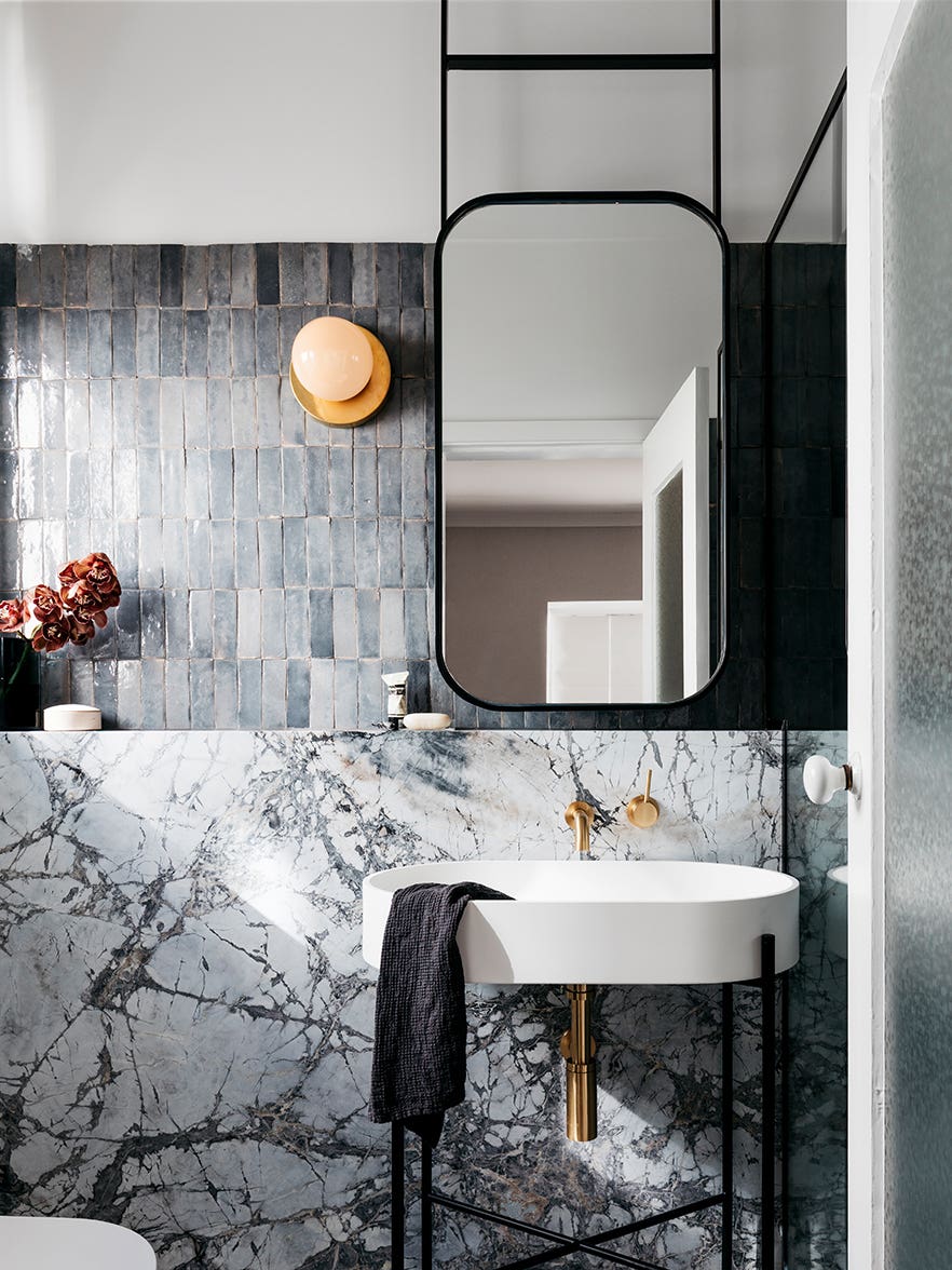 grey tile bathroom with marble backsplash