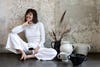 leanne ford in white outfit sitting near vessels