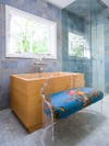 bathroom with wood tub and blue tile walls