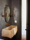 black bathroom walls and sand colored sink