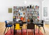 modern dining room with mismatched colorful chairs