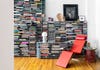 modern red recliner chair in front of bookshelves