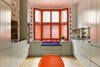 Kitchen window seat with orange shutters