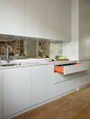 Light gray kitchen cabinets with orange interior
