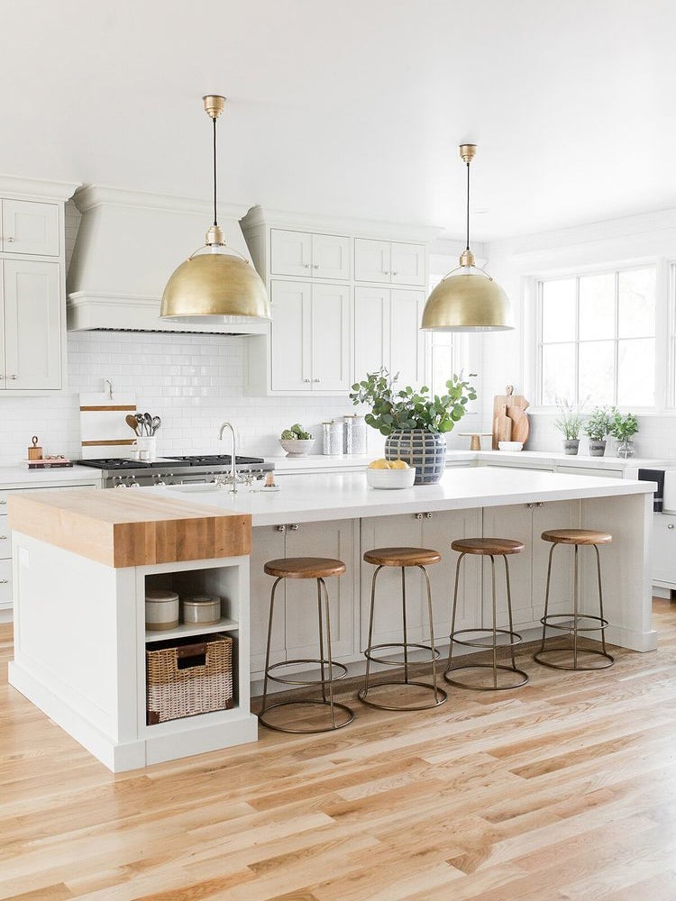 white kitchen with large brass lights