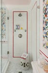 Shower with white subway tile and red border