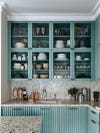 upper seafom colored cabinets with glass doors