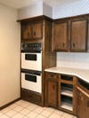 drab brown cabinets with double oven