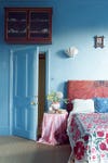 Red headboard in blue bedroom
