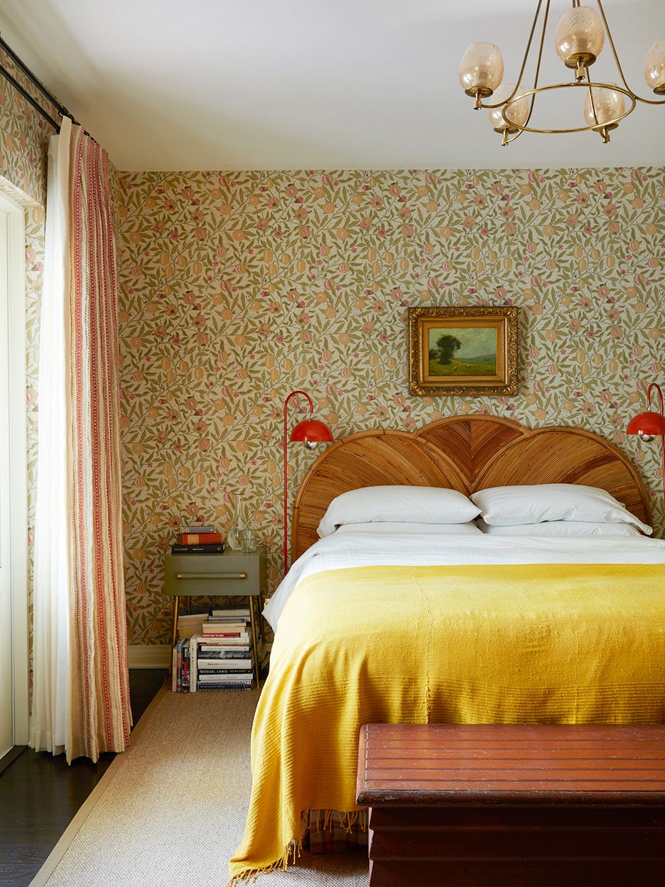 Bedroom with yellow bedspread and floral wallpaper