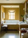 Yellow bathroom with marble tub