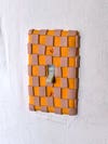 orange and pink light switch cover