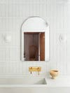 ruved mirror against subway tile 