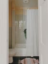 tiny bathroom with shower curtain