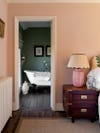 Pink bedroom with adjacent green bathroom