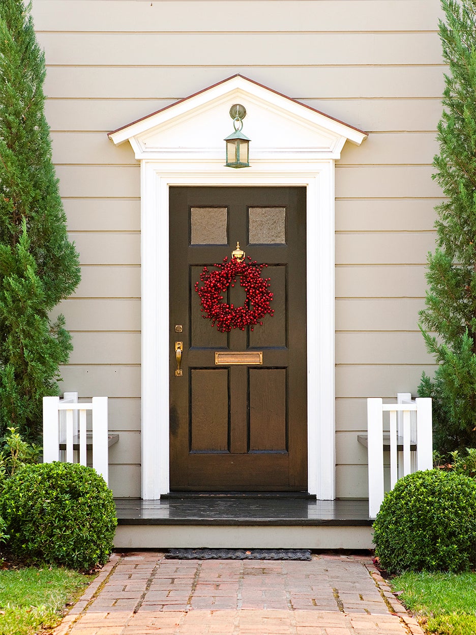 green front door with red wreath
