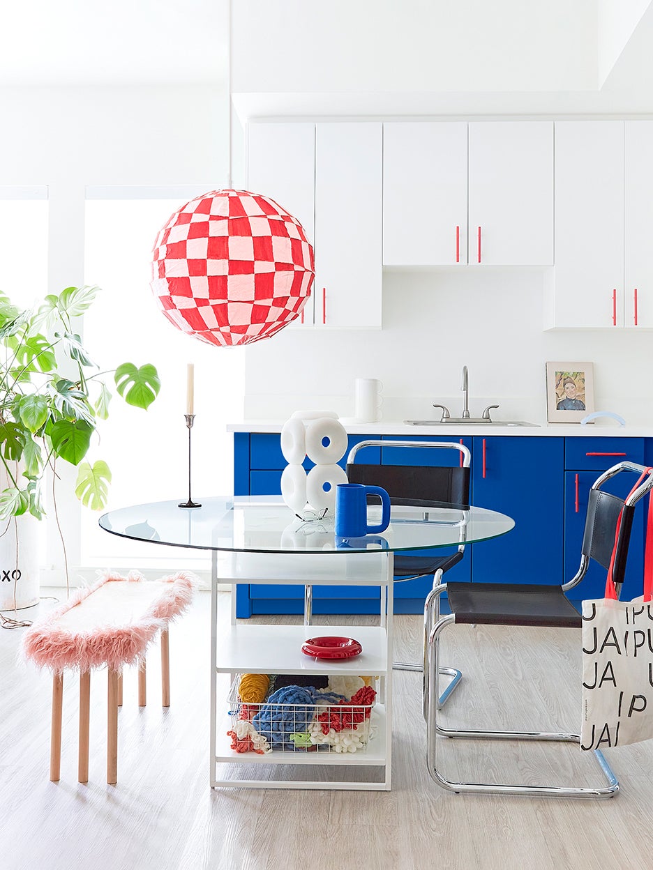 Rental kitchen with blue cabinets and checkered light