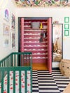 Nursery with green crib and pink closet
