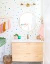 fun bathroom with polka dot wallpaper